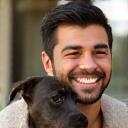 Client Luis smiling with puppy Bruno